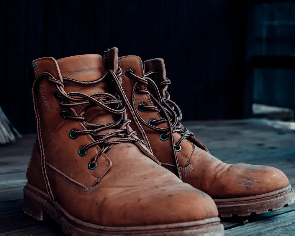 Worn leather boots on a wooden floor