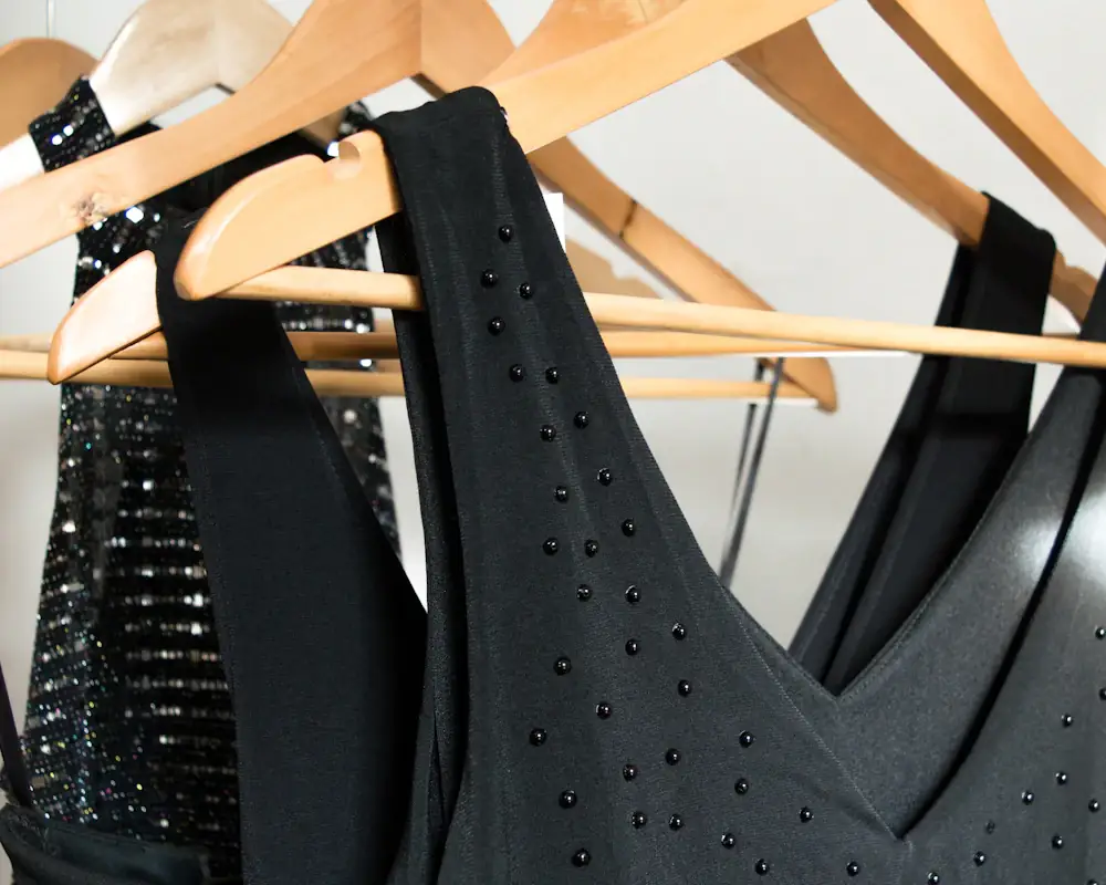 Black evening dresses on wooden hangers