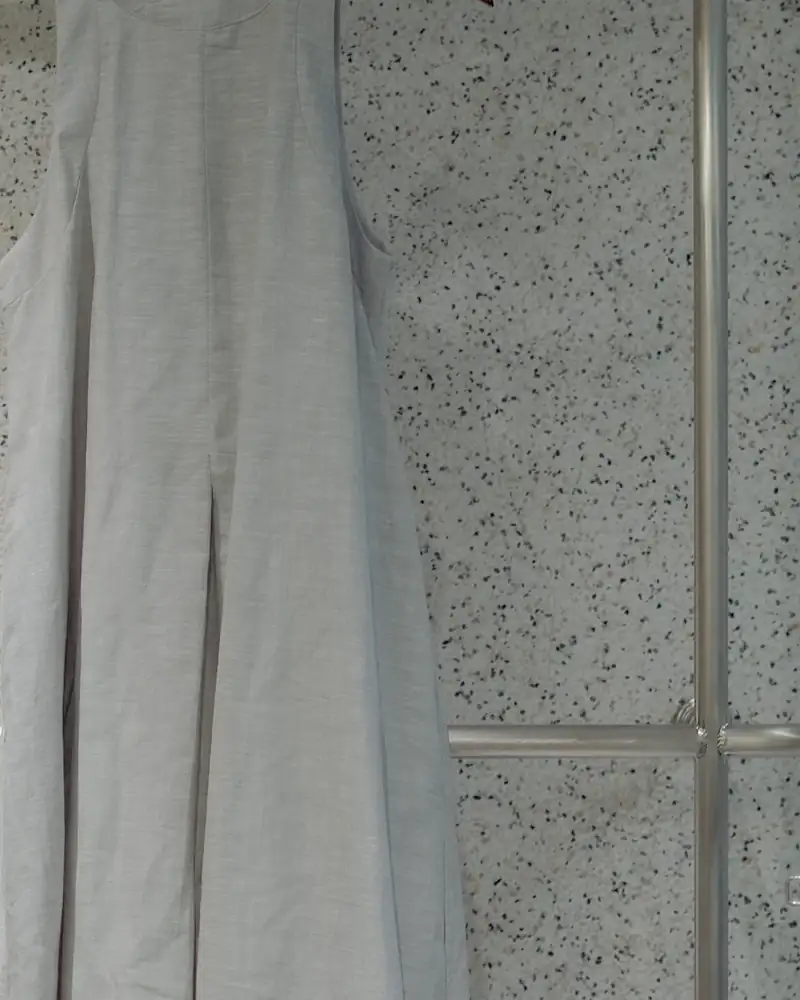 Stone shift dress on a clothes rail, close-up