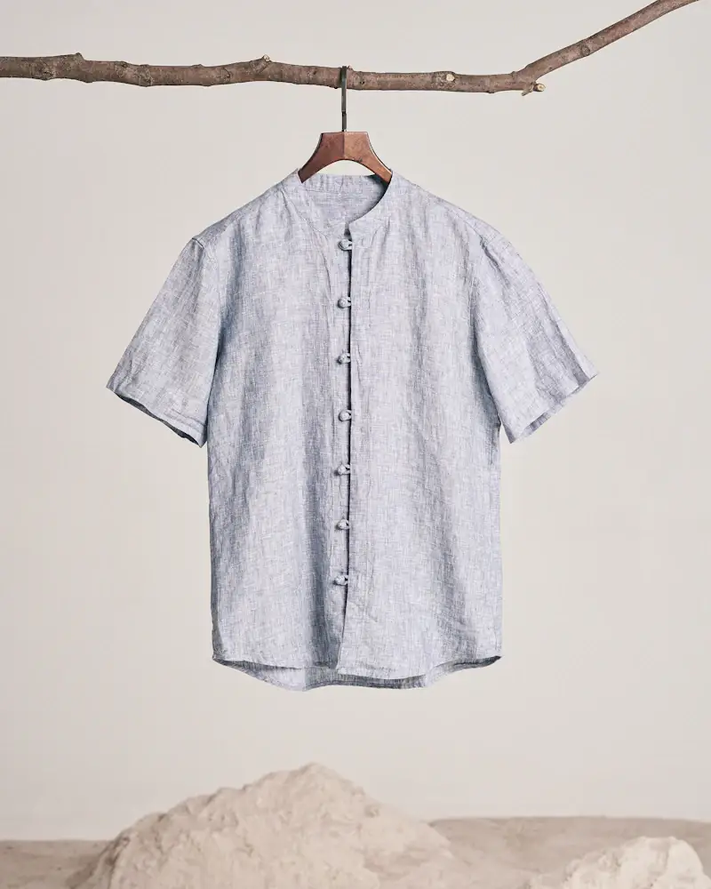 Sky blue linen shirt hanging from a branch
