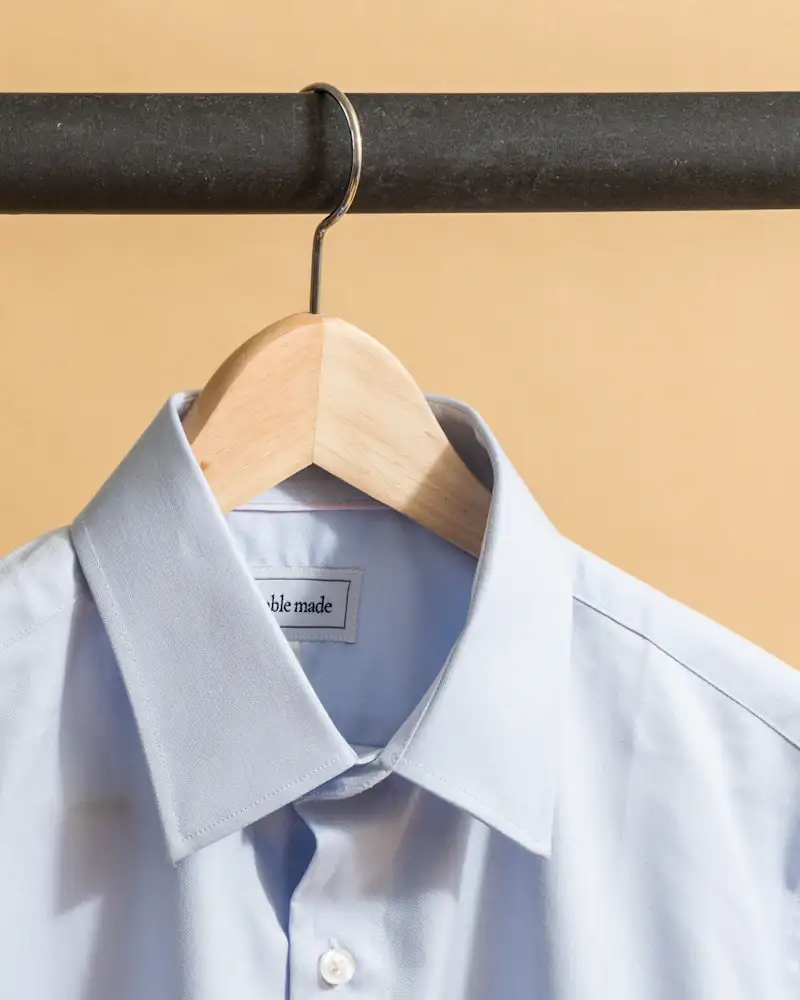 Pale blue oxford shirt on a hanger, close-up