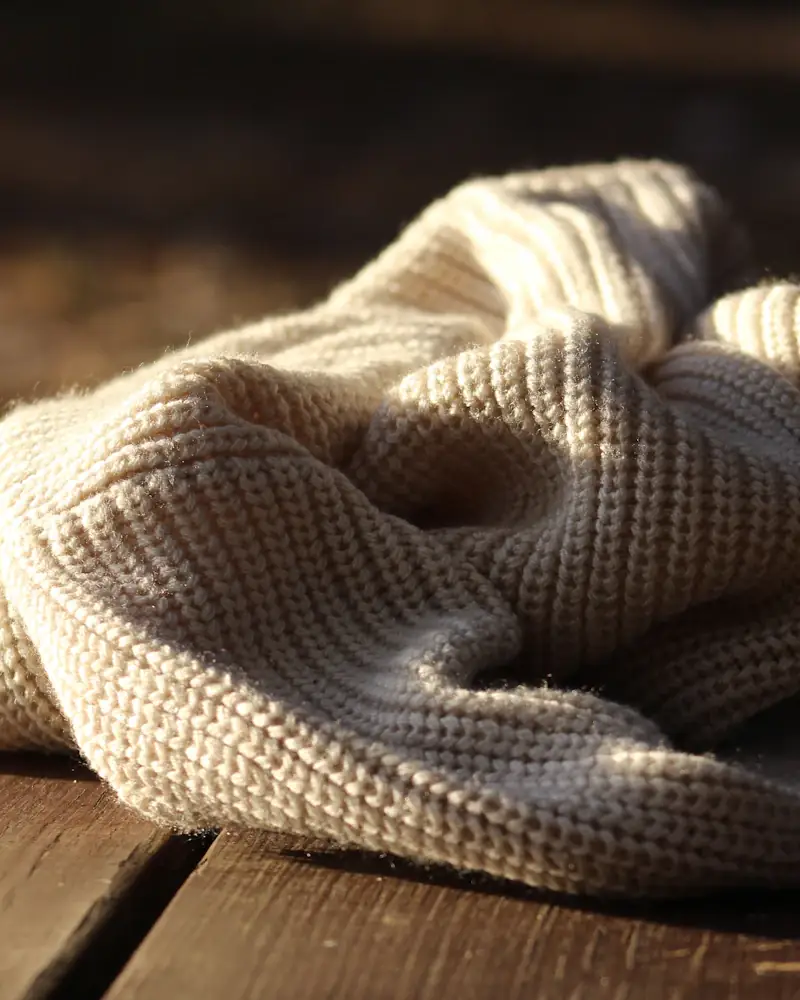 Undyed wool knit on a wooden bench