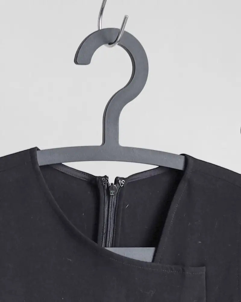 Midnight sleeveless dress on a grey hanger, close-up