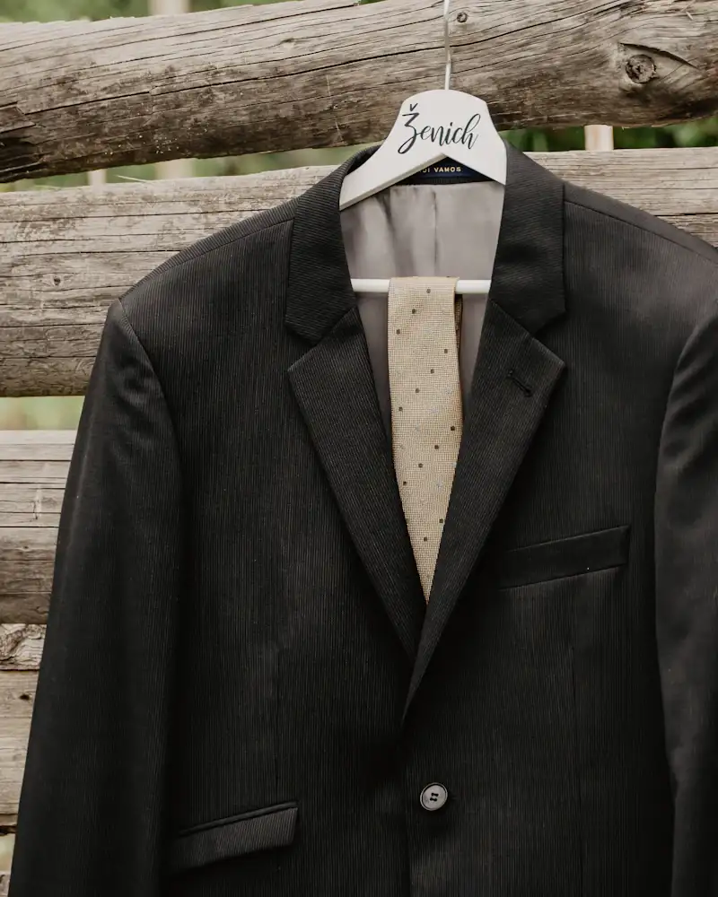 Black tuxedo blazer on a hanger, close-up