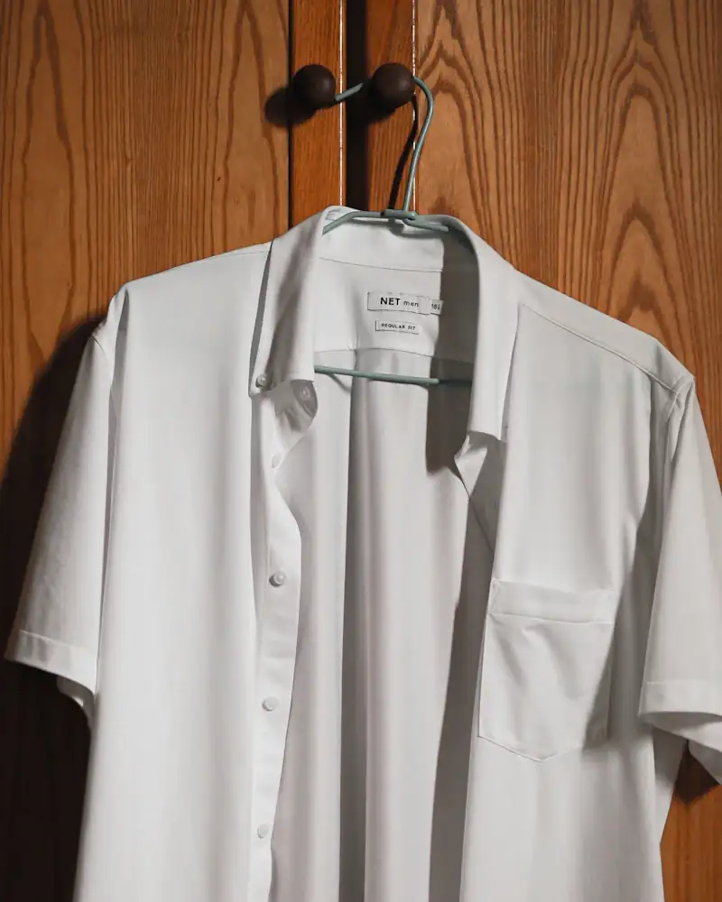 Bone poplin shirt on a hanger, close-up