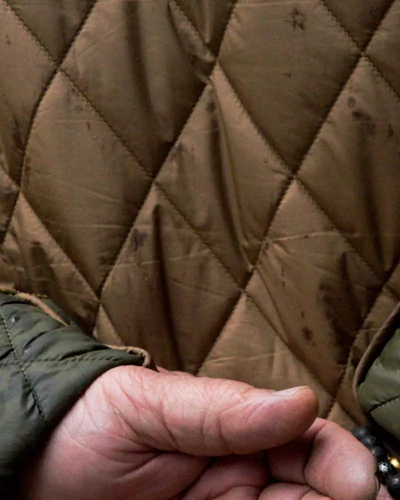 Olive quilted liner jacket, close-up