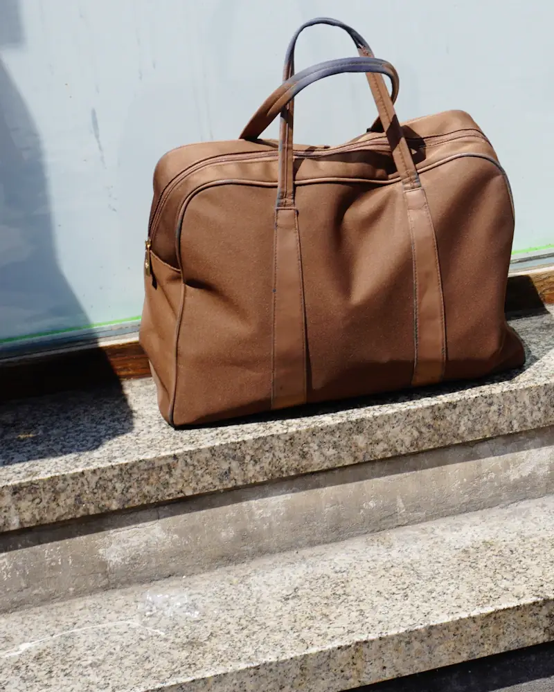 Saddle leather weekend bag on stone steps
